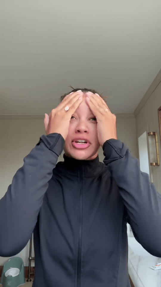 Montana Brown in a video, covering her face with her hands.