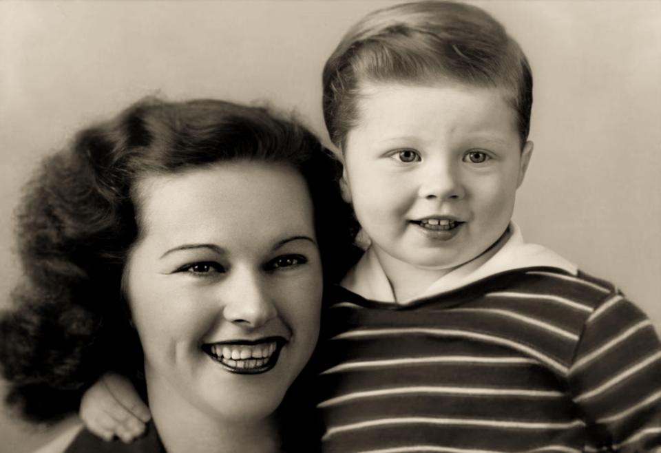 Robert Redford as a young boy with his mother, Marta W. Hart, in a sepia-toned photo.