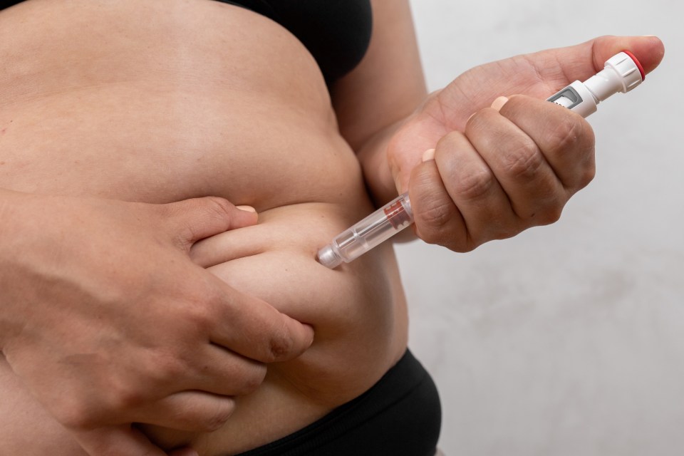 Woman makes a weekly subcutaneous injection of Semaglutide in the stomach for the treatment of type 2 diabetes.