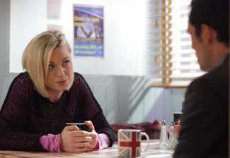 Roxy Mitchell and Michael Moon sit in a cafe, talking.
