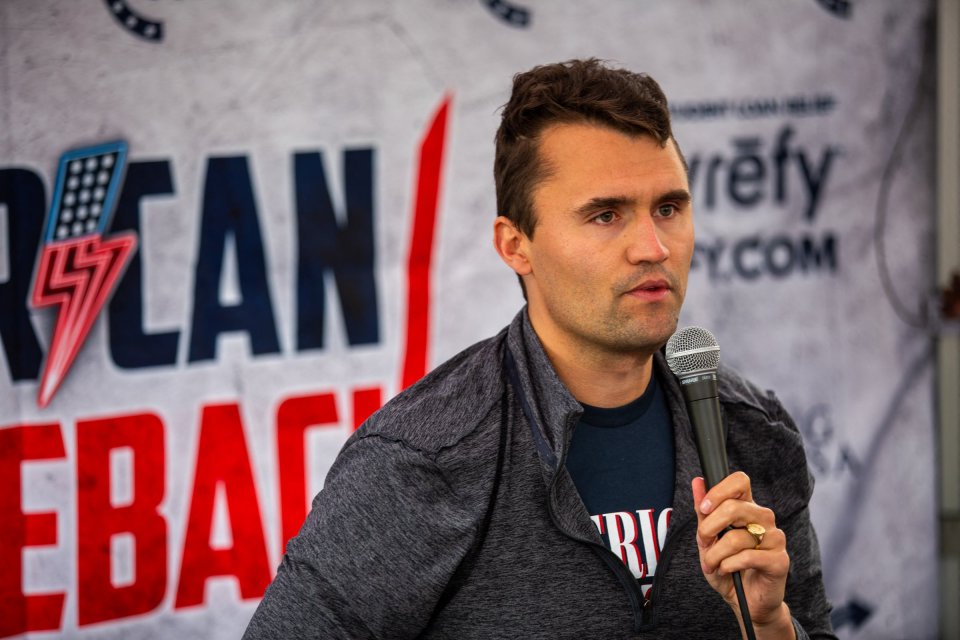Right-wing activist Charlie Kirk speaks into a microphone during his American Comeback tour.