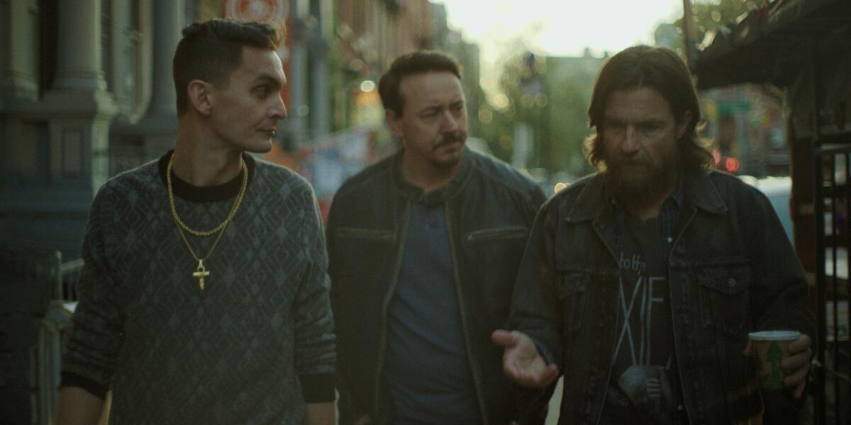 Three men walking down a New York street.