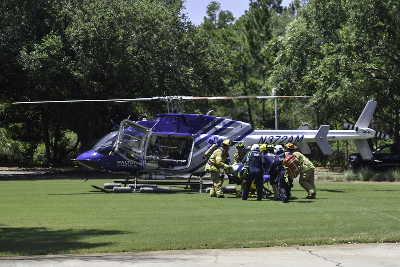 Rescue personnel loading a patient into a Walton Air Rescue helicopter.