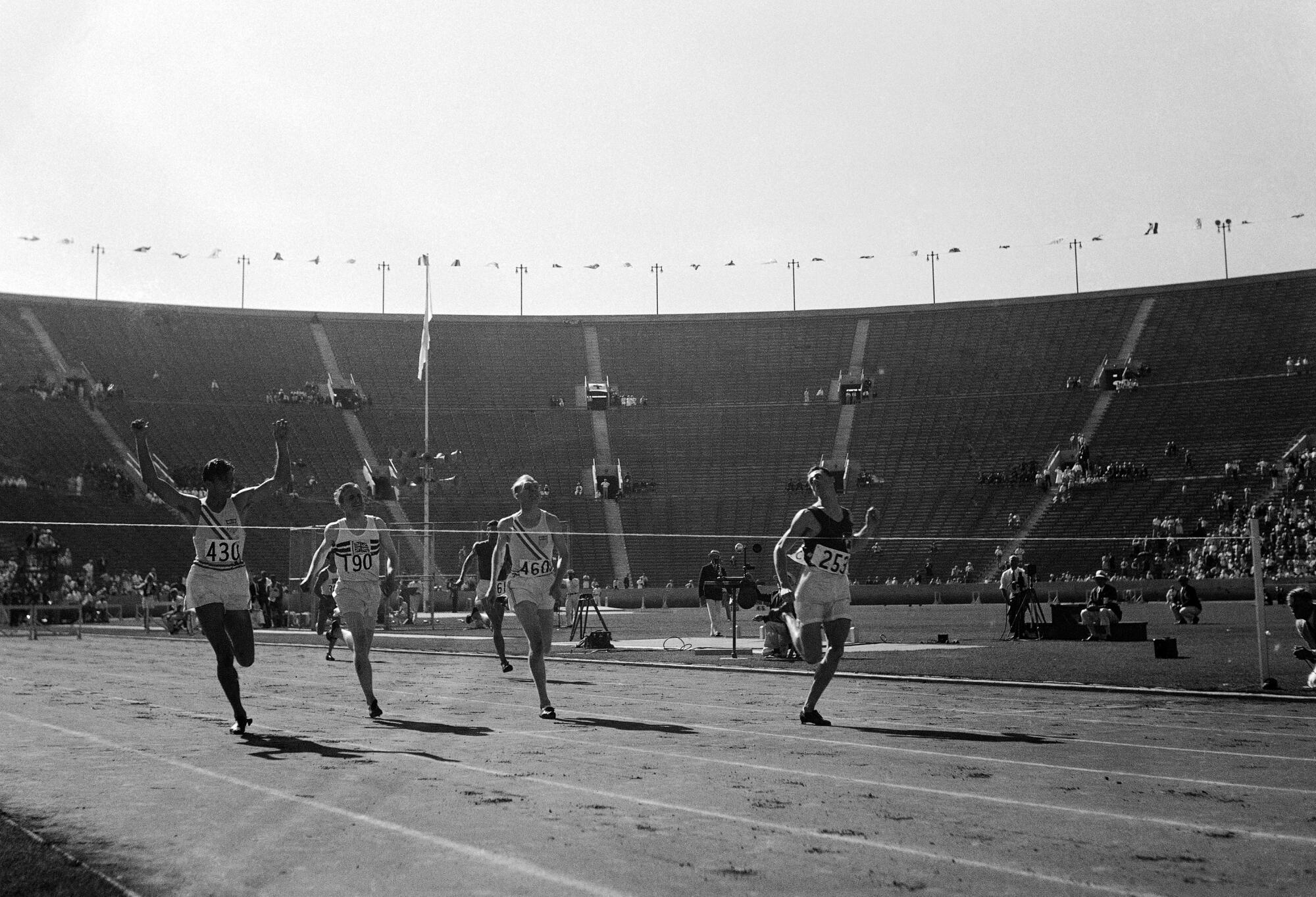 Four men cross the finish line in the 400-meter hurdles at the 1932 Summer Games in L.A.