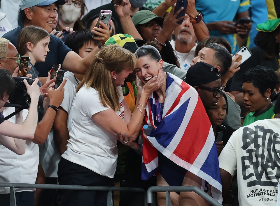 Amy Hunt of Team Great Britain embraces a woman in the crowd after winning silver in the Women's 200m.