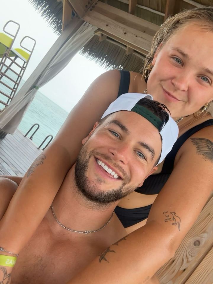 Jojo Siwa and Chris taking a selfie on a beach vacation.