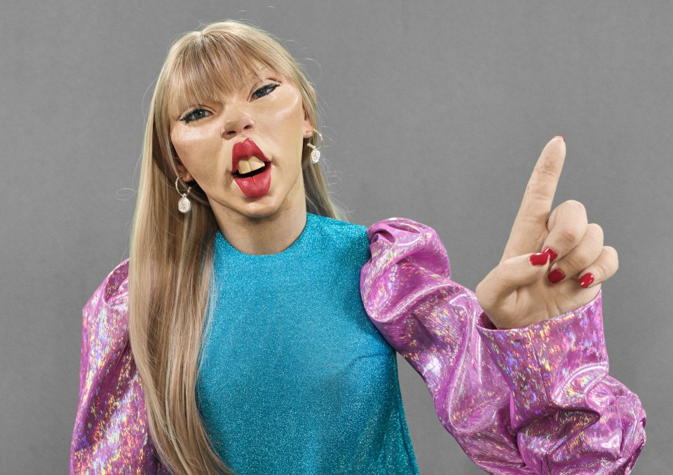 Illustration of a Taylor Swift puppet with exaggerated features, wearing a sparkly blue top and iridescent pink sleeves, raising a finger.