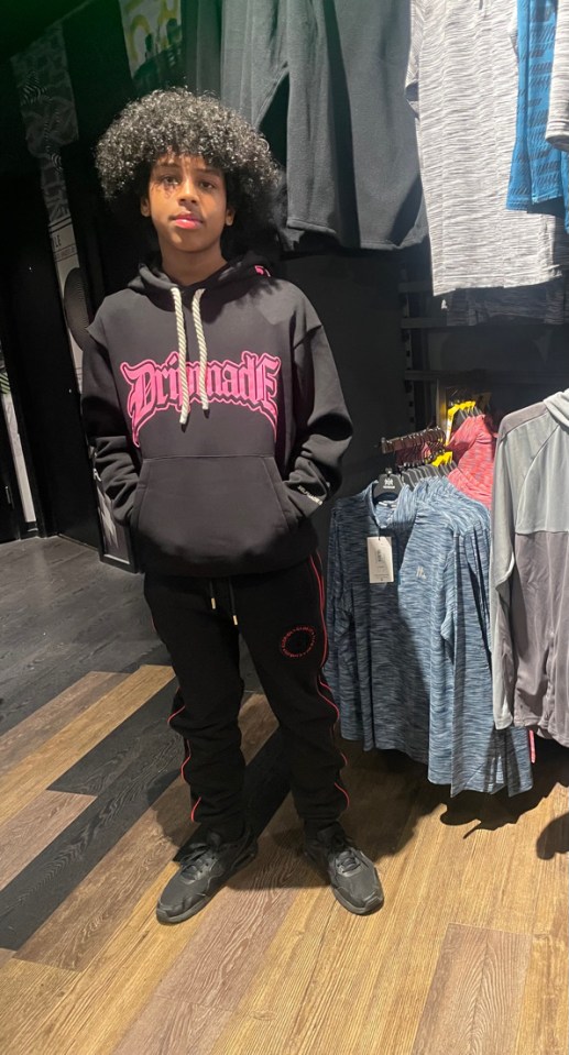 Mohanad Abdullaahi Goobe, a 15-year-old boy, in a black hoodie and sweatpants.