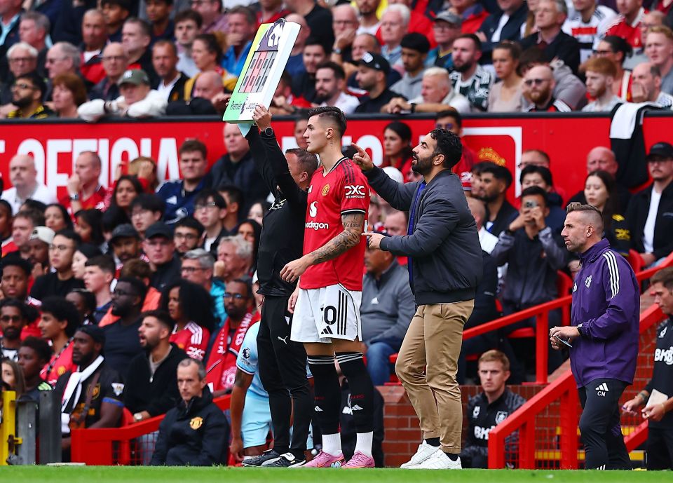 Manchester United manager and player on the sidelines.