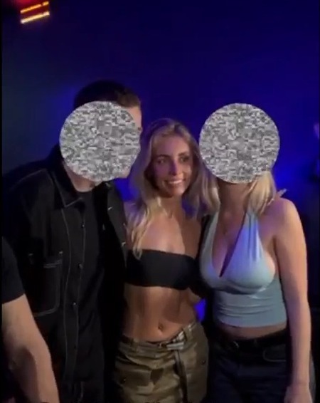 Adult star Bonnie Blue in a black tube top posing with two other people whose faces are pixelated, with text "South Yorkshire Police were reported attending the scene" overlaid.