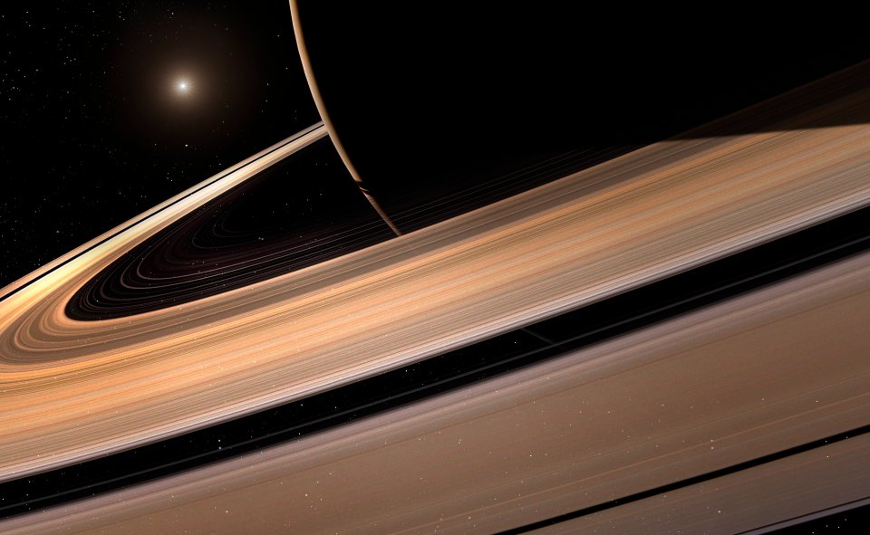 Illustration of Saturn's rings with the planet partially visible, and a distant star in the dark sky.