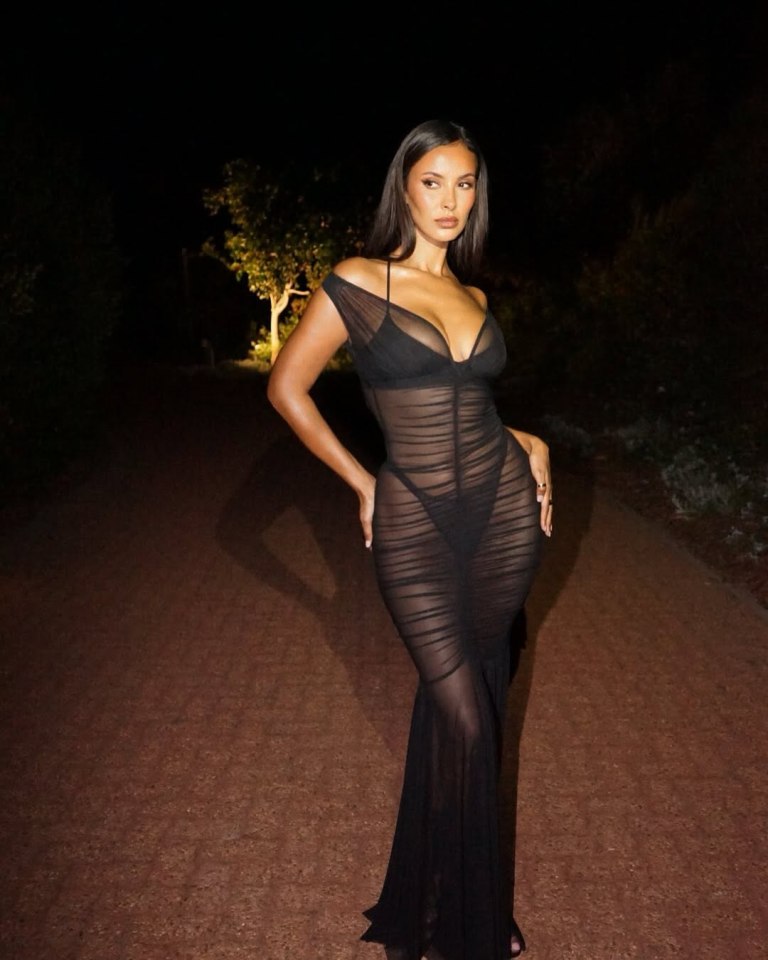 Maya Jama in a sheer black gown with a plunging neckline and bare shoulders.