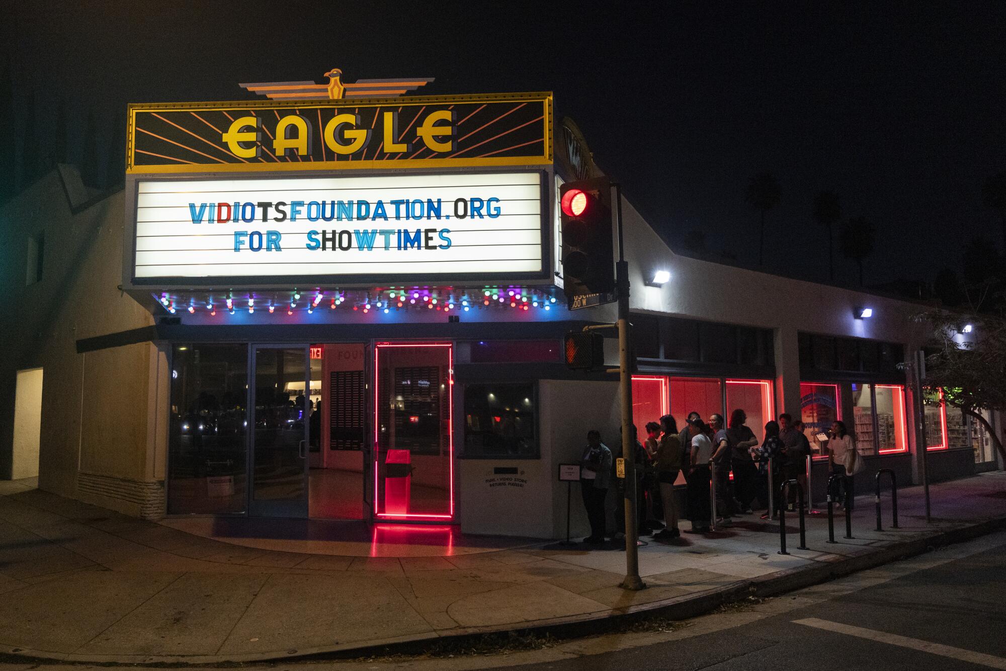 Guests wait to enter the Vidiots movie theater in Los Angeles.