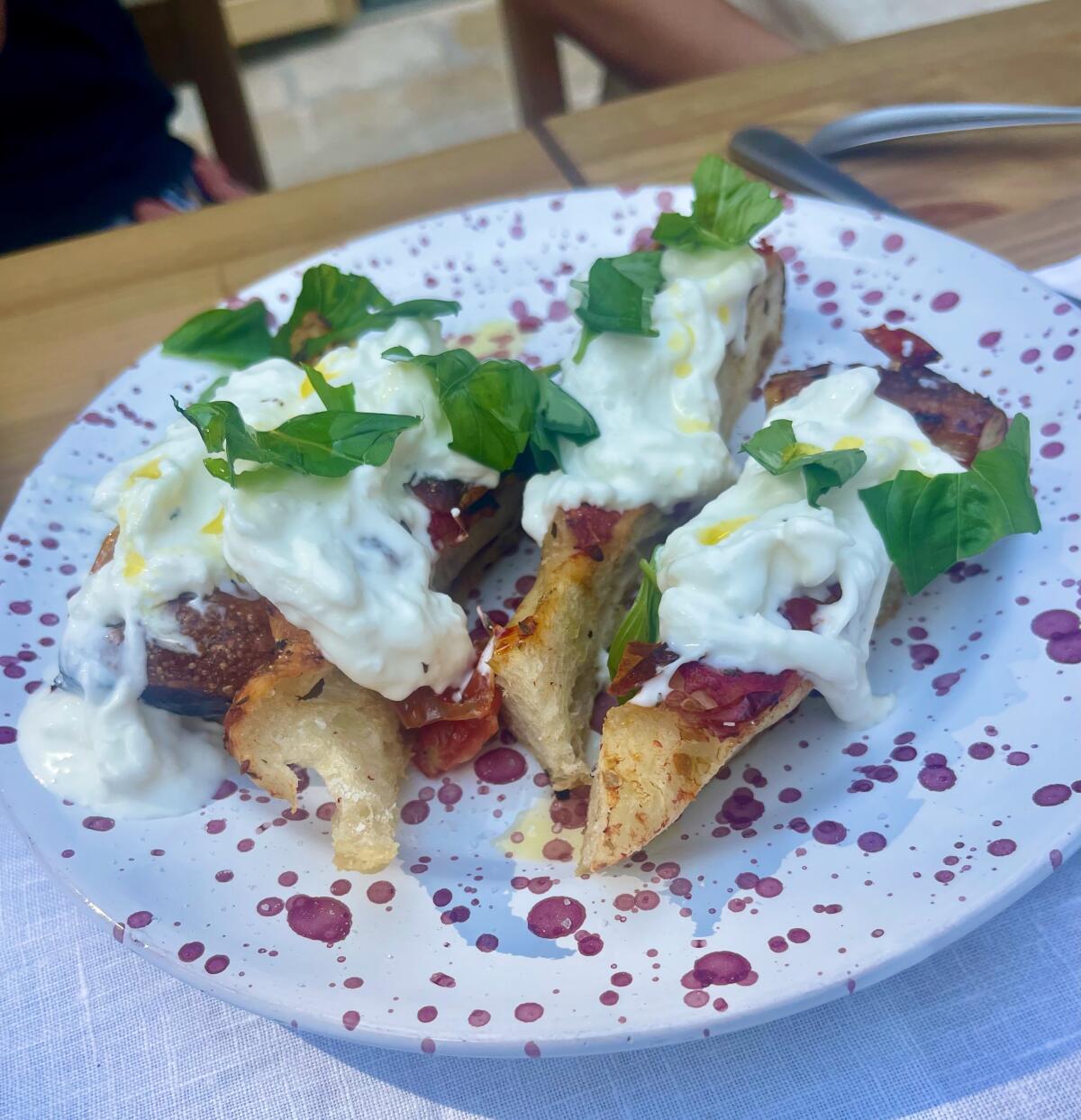 Focaccia with fresh stracciatella at Baby Dicecca in Puglia's Mercadante Forest.