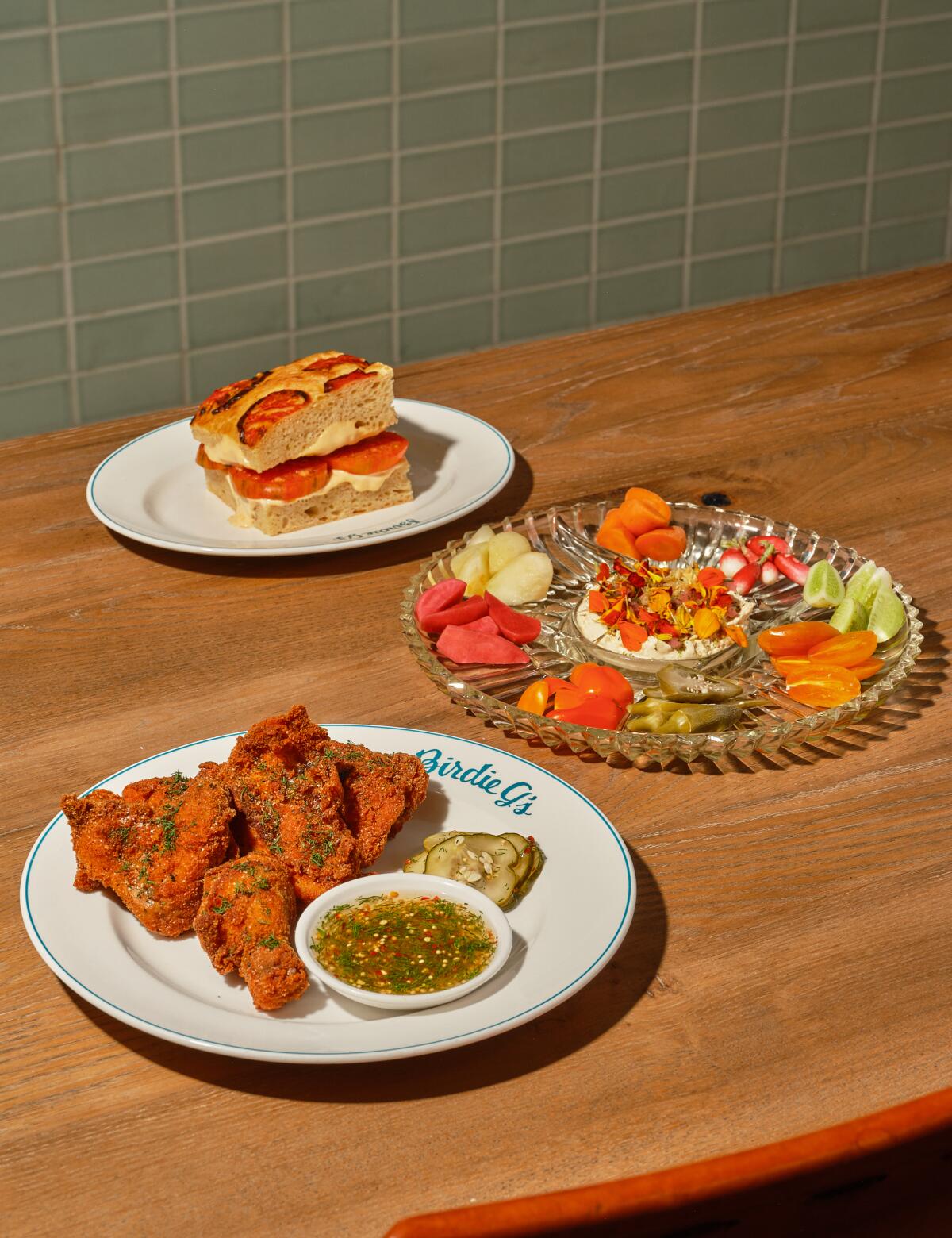 SANTA MONICA , CA-OCT 11, 2022: Birdie G's Knife and Fork Tomato Sandwich, Relish Tray, and Pickle Chick cutlet