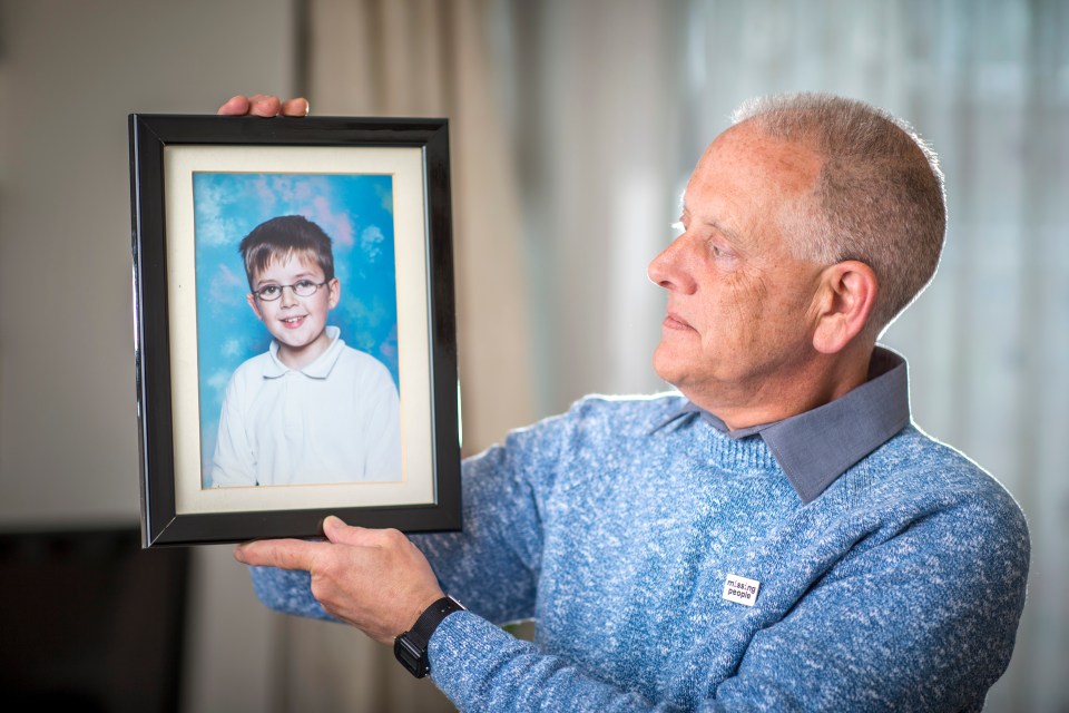 Kevin Gosden, father of missing Andrew Gosden, holds a framed photograph of his son.
