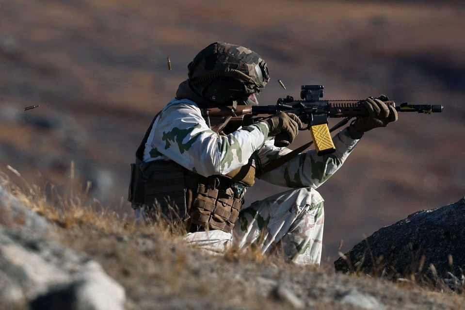 A member of the French armed forces fires a weapon during a military drill.