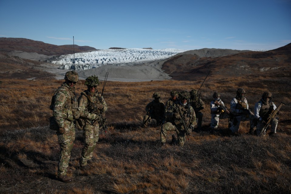 Members of the Danish and French armed forces practice looking for potential threats during a military drill in Kangerlussuaq, Greenland.