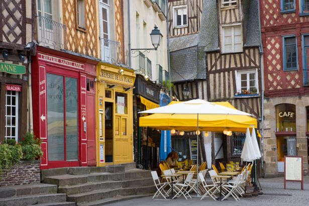 Image of empty streets of Rennes, with colourful buildings and storefronts