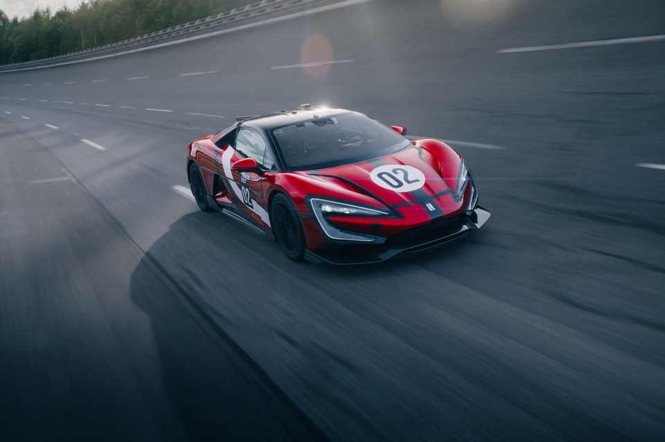 Yangwang U9 Xtreme in red, white, and black racing livery on a track.