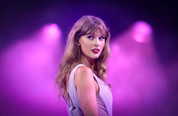 Taylor Swift looks over her right shoulder
