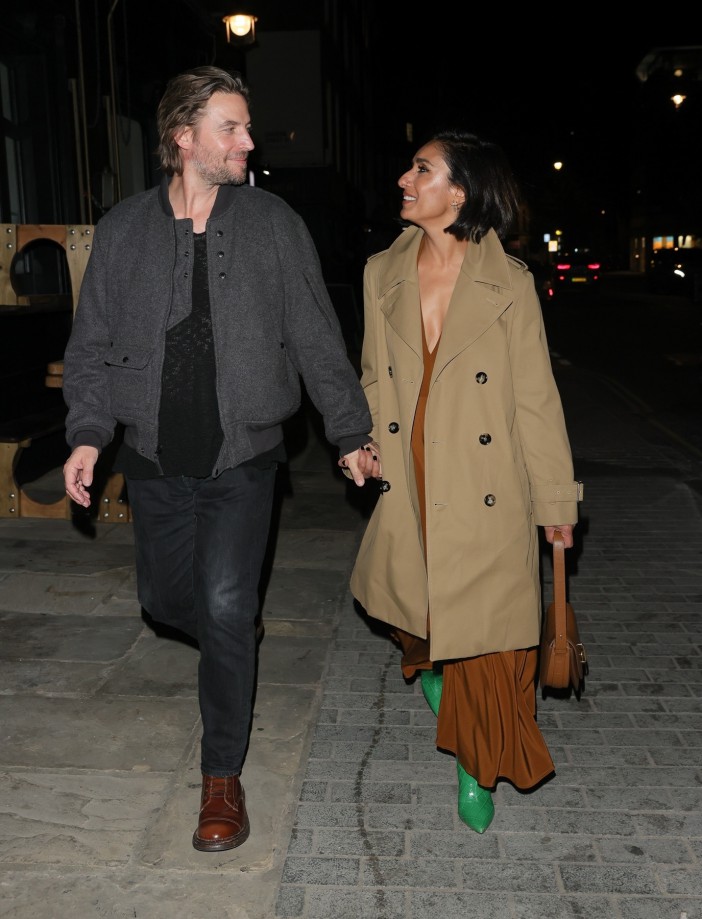Anita Rani and her new boyfriend holding hands at a Burberry London Fashion Week afterparty.