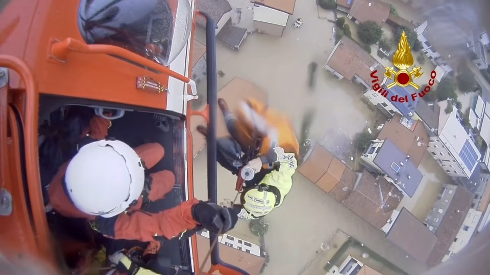 A helicopter rescue worker being lowered to flood victims in Meda, Brianza, Lombardy.