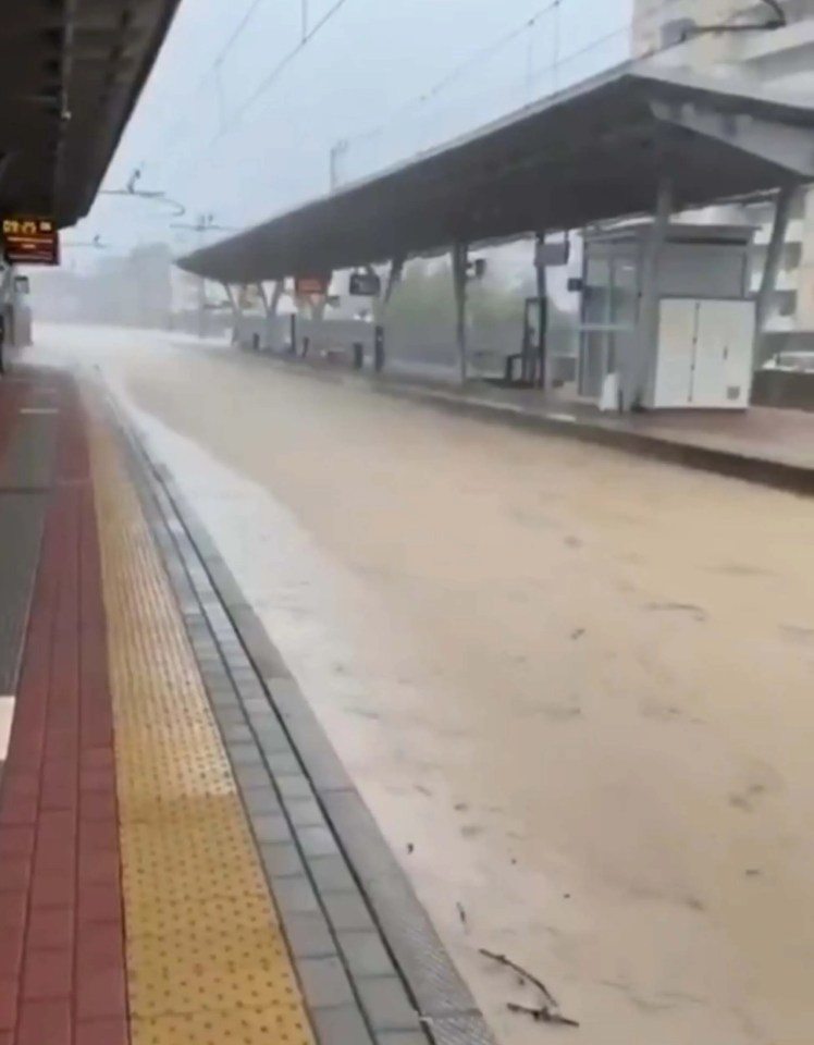 Flooded train tracks at a station during heavy rain in Northern Italy.
