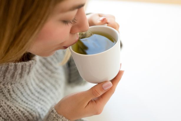 Stock image of a woman drinking herbal tea
