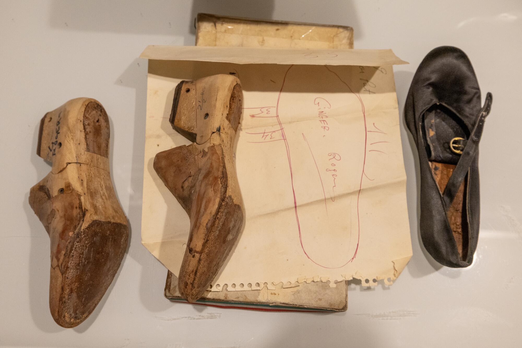 Wooden shoe lasts lie next to a shoe in progress for Ginger Rogers made by Pasquale Di Fabrizio