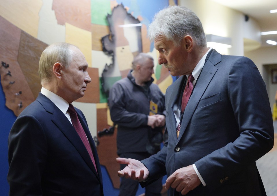 Russian President Vladimir Putin speaks with Kremlin spokesman Dmitry Peskov.