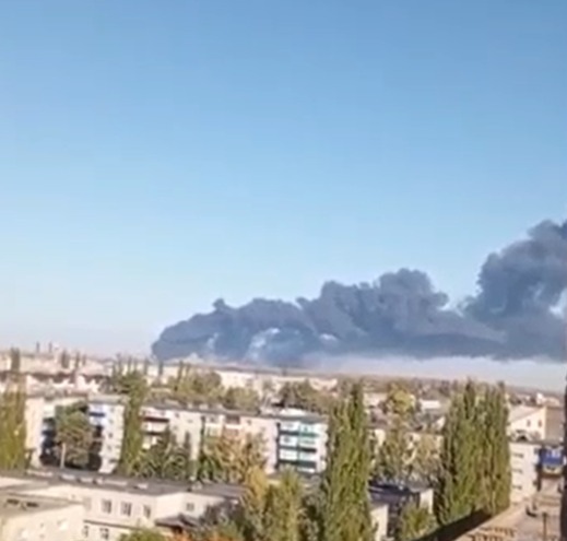 Dark smoke rising from an explosion over a city.