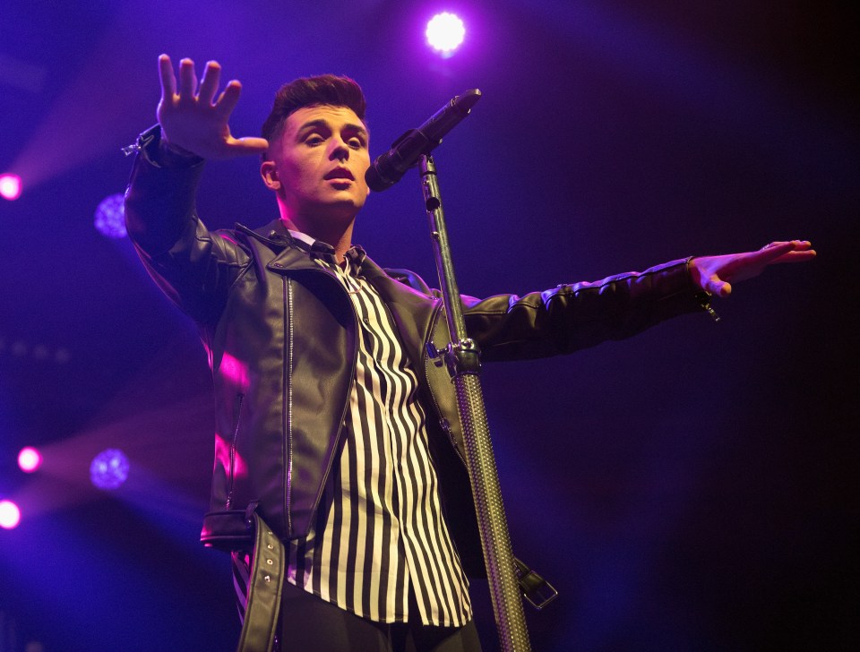 Jaymi Hensley of Union J performing on stage.