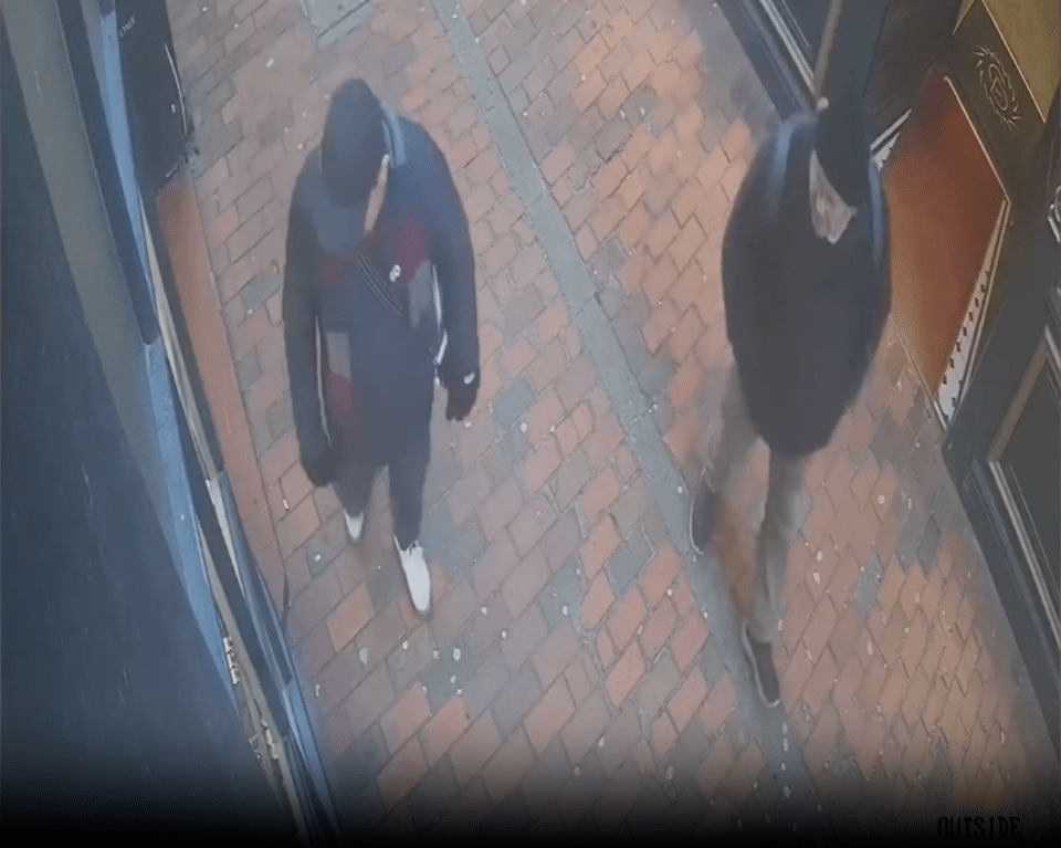 Two men walk on a brick sidewalk from an overhead view.