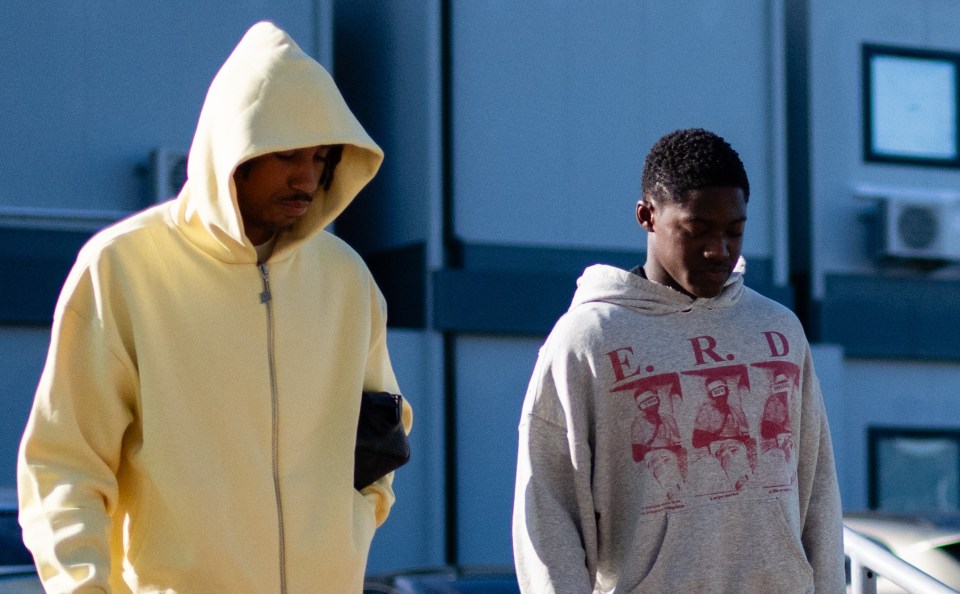 Leny Yoro in a yellow tracksuit and Kobbie Mainoo in a grey hoodie arriving at a training session.