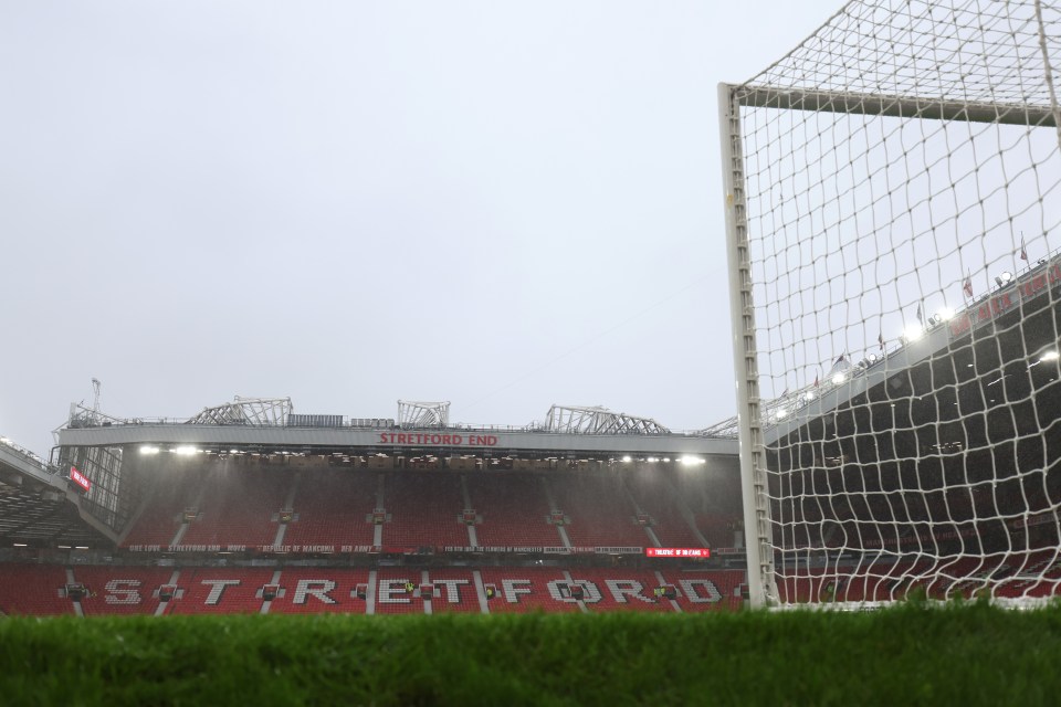 View inside Old Trafford stadium prior to the Premier League match, showing the Stretford End stand and a goalpost.