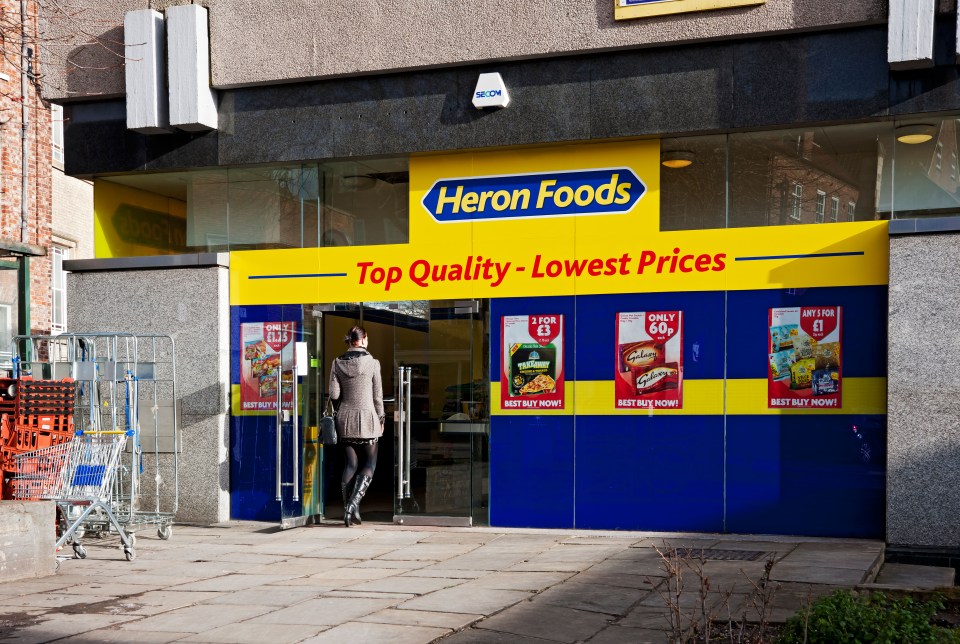 Entrance to Heron Foods supermarket with a person entering.