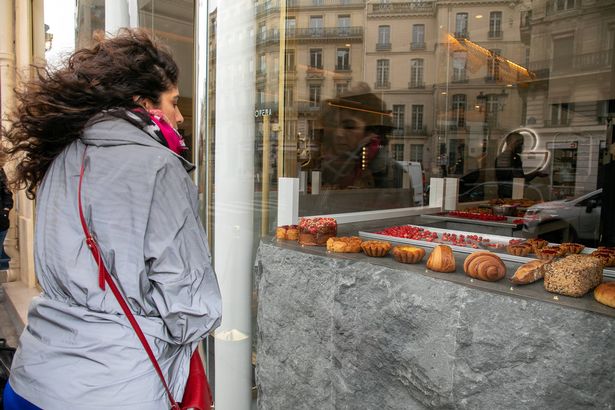  A client is seen queueing in front of the Cedric Grolet bakery shop on Avenue de l'Opera