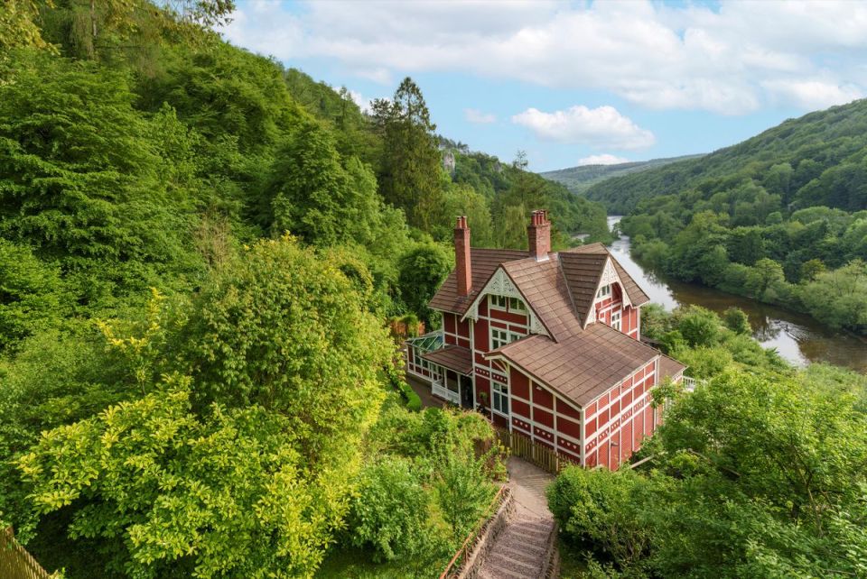 The red house from the TV series Sex Education with a river in the background.
