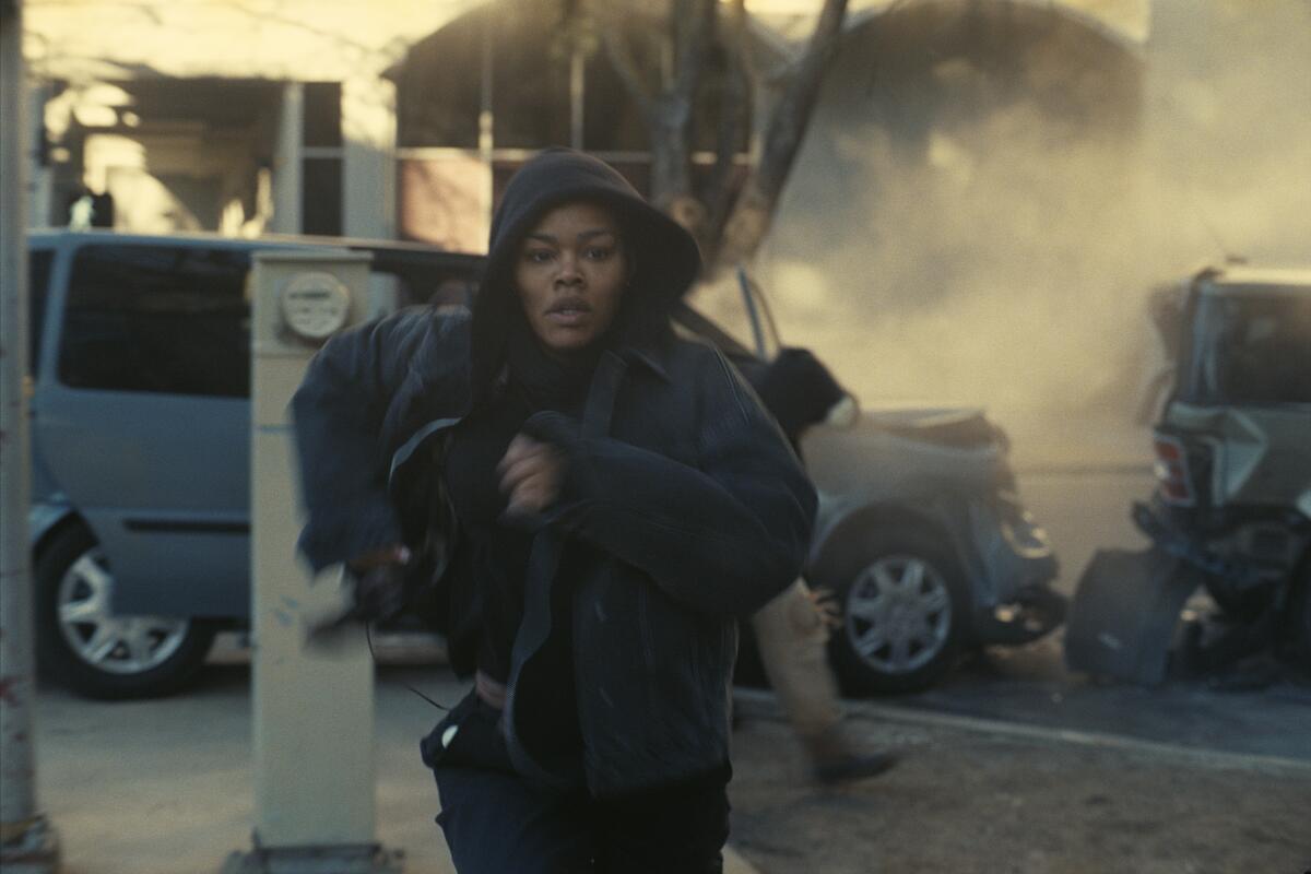 A woman flees from an explosion.