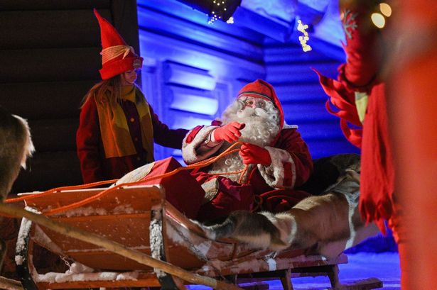 Father Christmas, greets children from the Santa's Village at the Arctic Circle in Finnish Lapland