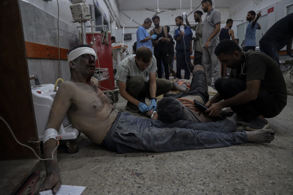 Palestinians, including children, receive treatment in a hospital after Israeli attacks on the Al Shati Refugee Camp.