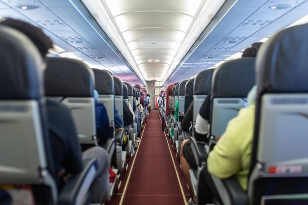Passengers traveling by a plane, shot from the inside of an airplane