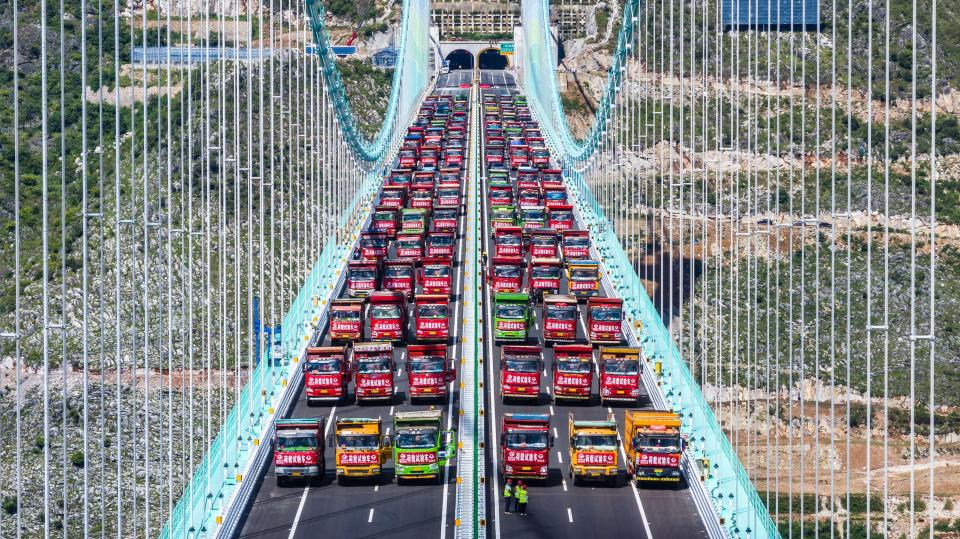Aerial view of trucks on the Huajiang Grand Canyon Bridge during a load test.