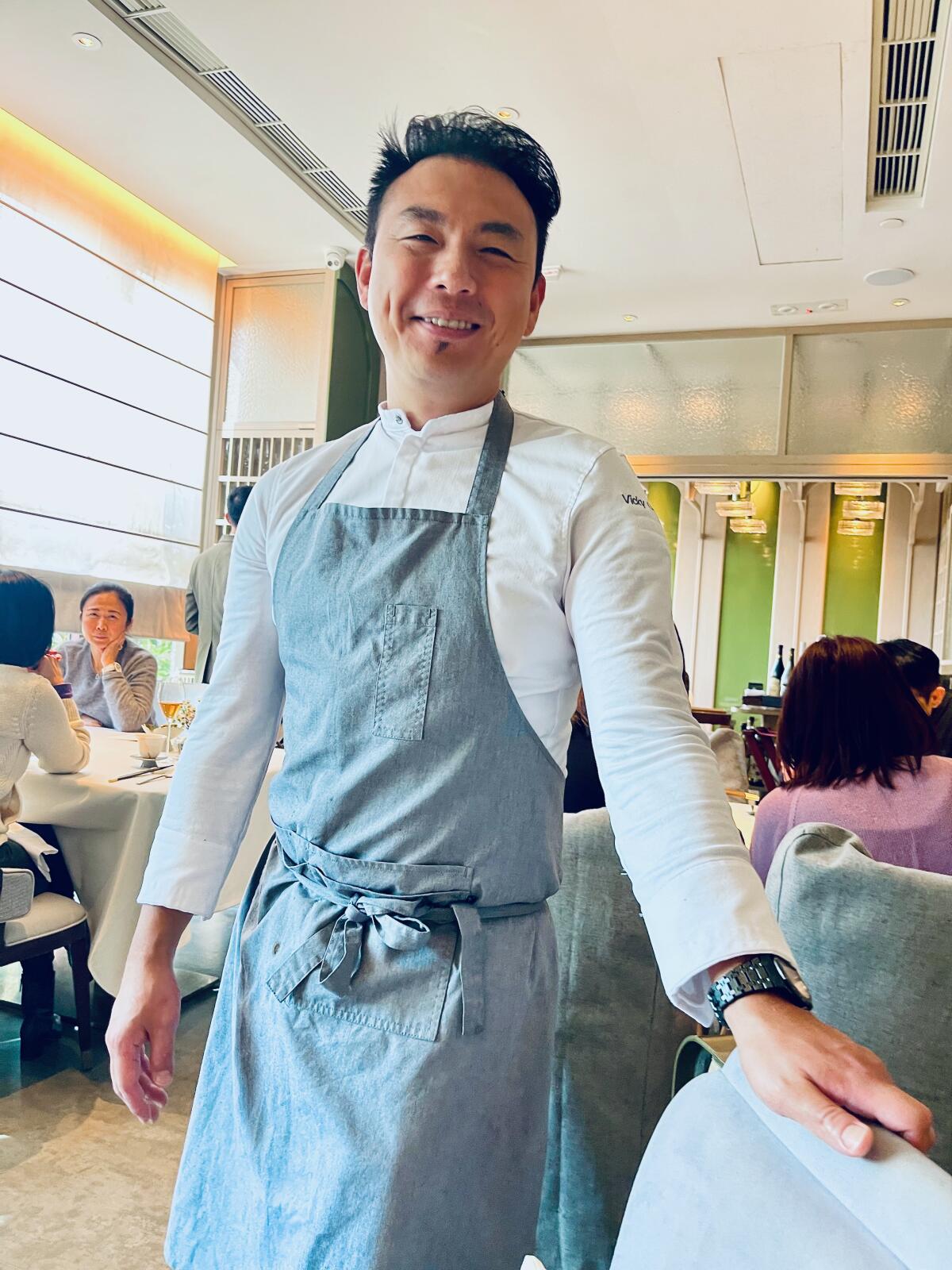 Chef Vicky Cheng stands in the dining room of his Hong Kong restaurant Wing.