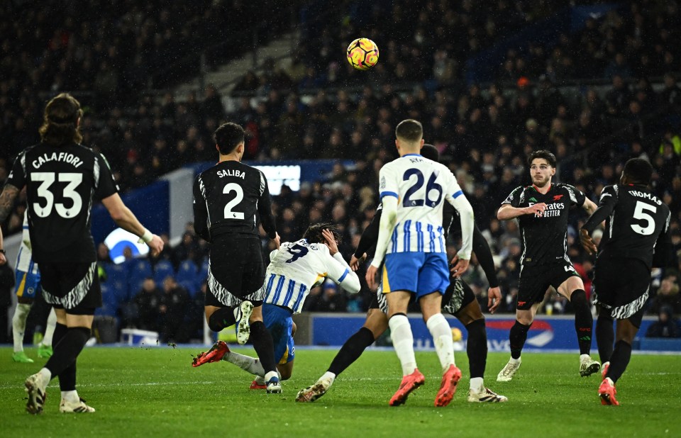 Arsenal's William Saliba fouls Brighton & Hove Albion's Joao Pedro in a soccer match.