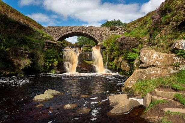 Old packhorse bridge over the river Dane where waterfalls mark where the counties of Staffordshire, Cheshire and Derbyshire meet. A popular scenic location for walkers.