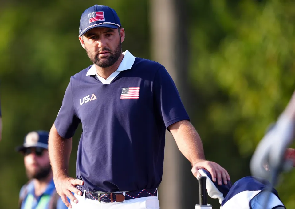 Scottie Scheffler in a blue polo shirt and hat with USA branding.