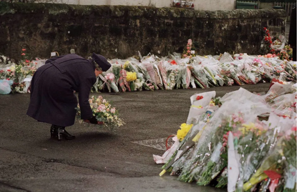 Queen Elizabeth placing a floral bouquet at Dunblane Primary School.
