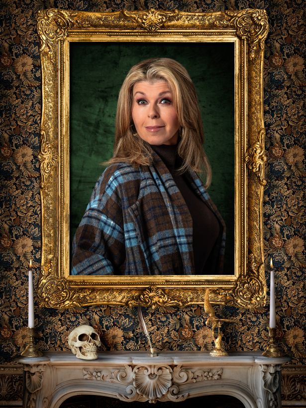 Kate Garraway smiles in a checked cape